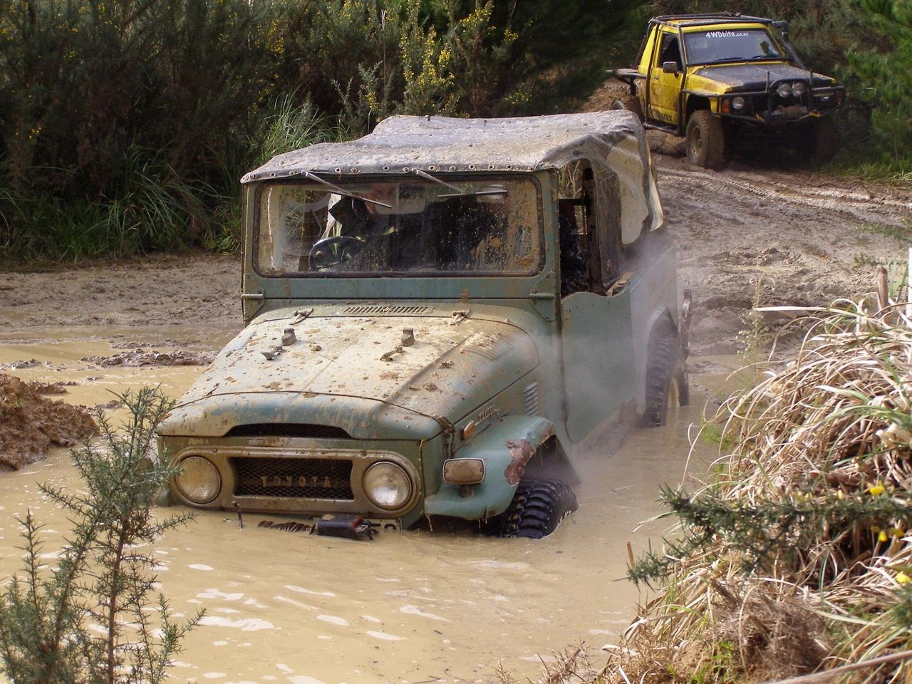 Classic off-road vehicle in muddy water