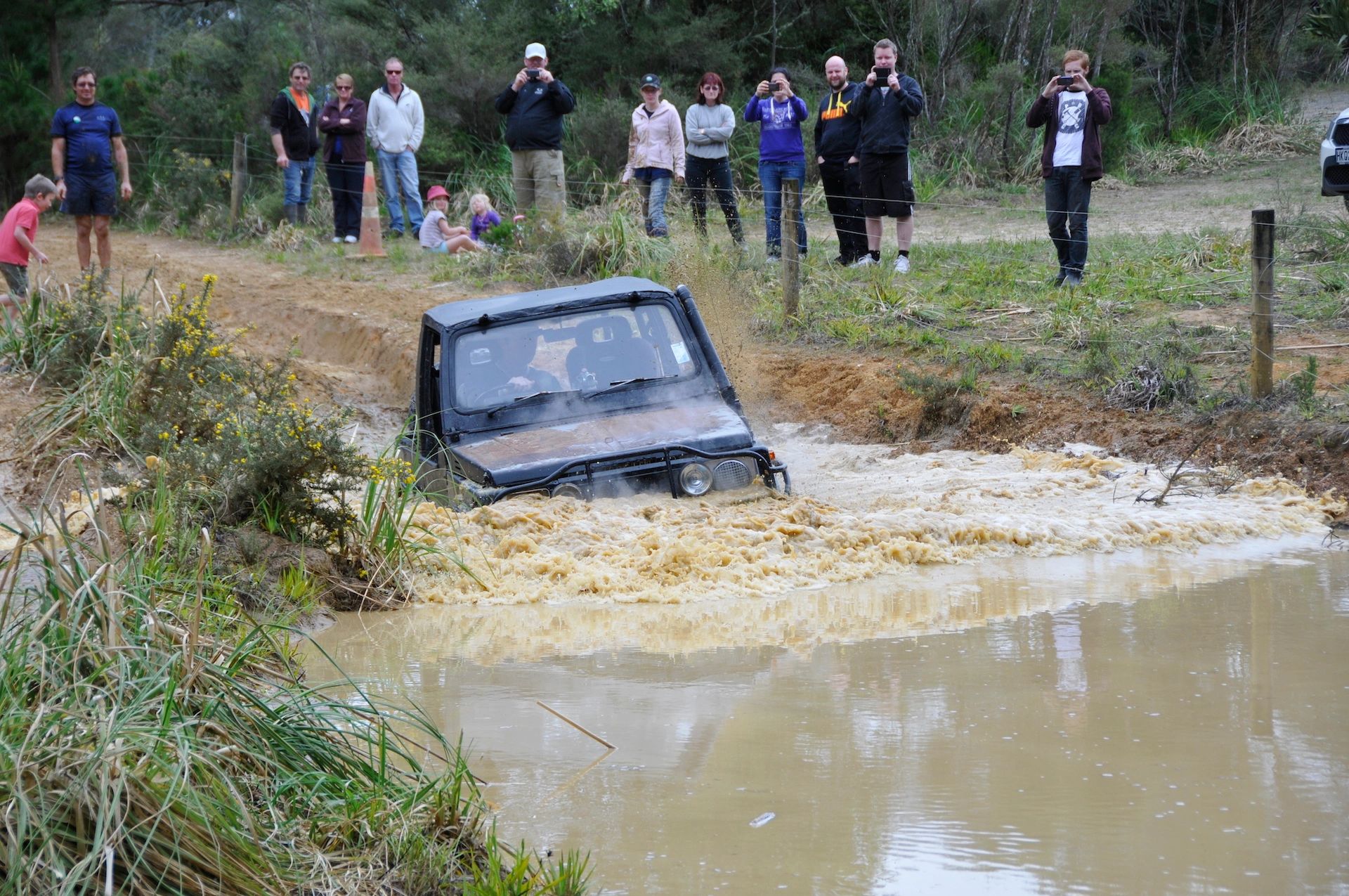 Vehicle splashing through a water hole
